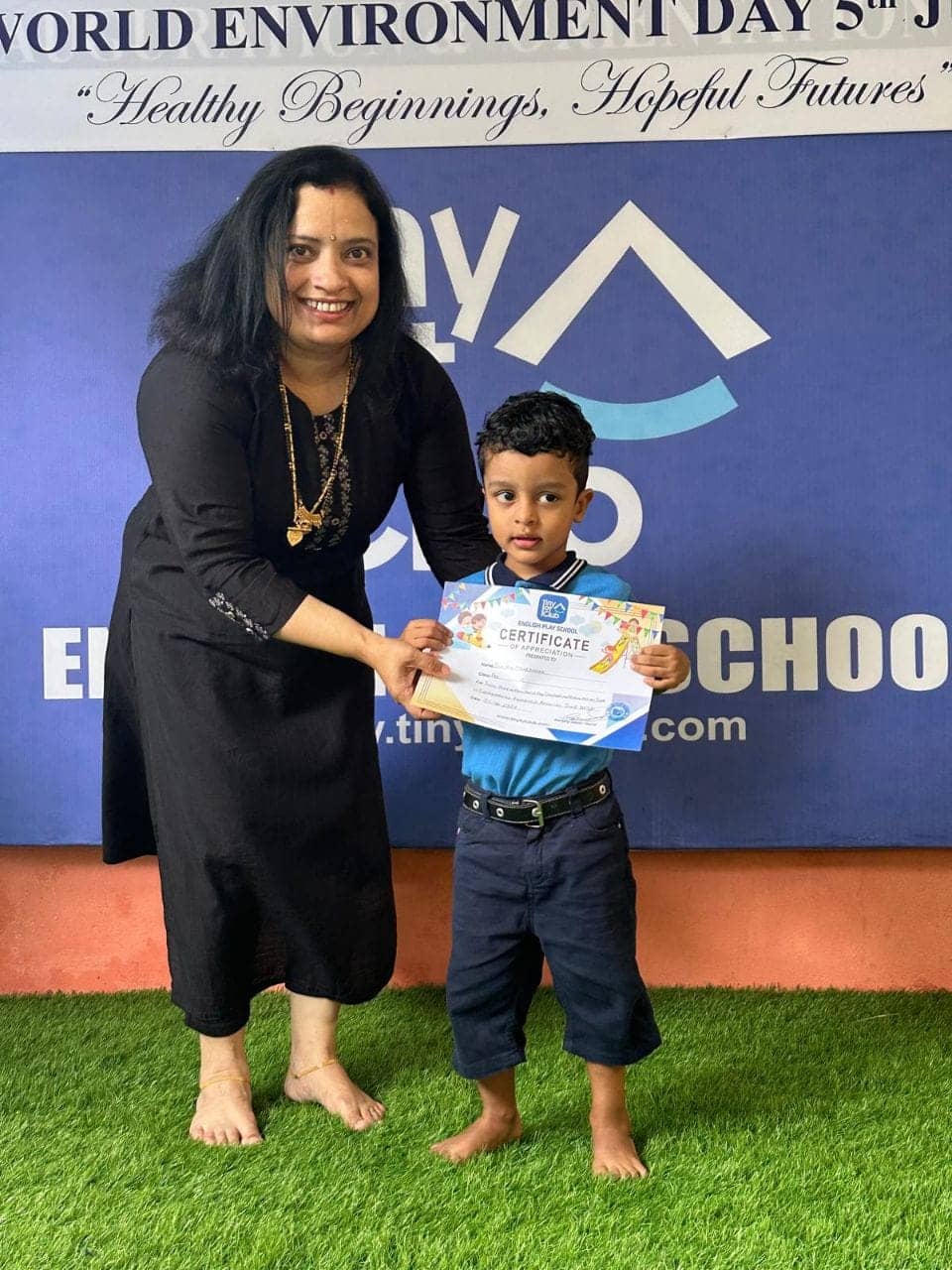 Student with World Environment Day certificate