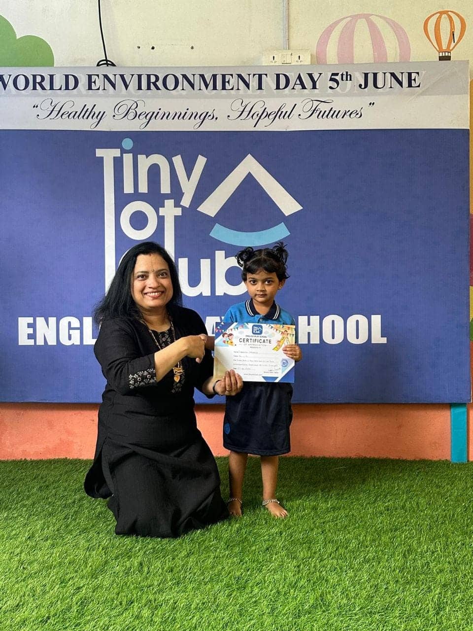 Student receiving World Environment Day certificate